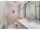 Charming bathroom with pink wallpaper, marble vanity, and an ornate mirror at 12710 Old Surrey Pl, Roswell, GA 30075