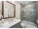 Bathroom featuring modern vanity, bathtub with glass enclosure, and neutral gray tones at 12710 Old Surrey Pl, Roswell, GA 30075