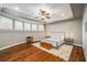 Serene bedroom with hardwood floors, natural light, and modern ceiling fan at 12710 Old Surrey Pl, Roswell, GA 30075