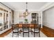 Formal dining room featuring hardwood floors and adjacent butler's pantry at 12710 Old Surrey Pl, Roswell, GA 30075