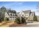 Elegant two-story home boasts a three-car garage, manicured landscaping, and a welcoming front entrance at 12710 Old Surrey Pl, Roswell, GA 30075