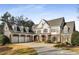 Charming two-story home features a three-car garage, covered front porch, and well-maintained landscaping at 12710 Old Surrey Pl, Roswell, GA 30075