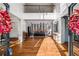 Elegant foyer with hardwood floors, a grand staircase, and a view into the living room at 12710 Old Surrey Pl, Roswell, GA 30075