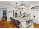 Bright, modern kitchen with a large island, pendant lighting, stainless steel appliances, and sleek white cabinets at 12710 Old Surrey Pl, Roswell, GA 30075