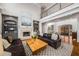 Inviting living room boasts a stone fireplace, built-ins, and rich hardwood floors at 12710 Old Surrey Pl, Roswell, GA 30075