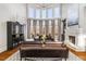 Living room with cathedral ceilings, fireplace, view of the balcony, and natural lighting at 12710 Old Surrey Pl, Roswell, GA 30075