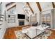 Living room with vaulted ceiling, fireplace, built-in shelving, and view of the balcony at 12710 Old Surrey Pl, Roswell, GA 30075