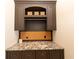 Functional office nook with granite countertops, storage cabinets, and cork board at 12710 Old Surrey Pl, Roswell, GA 30075