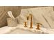 Close-up view of a half bathroom sink with marble countertops and elegant gold faucet at 12710 Old Surrey Pl, Roswell, GA 30075