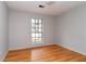 Bedroom with hardwood floors, neutral paint, and a large window overlooking the front yard at 1850 Cashmere Ct, Lithonia, GA 30058