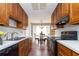 Galley kitchen showcasing wood cabinets and a view into the breakfast area at 1850 Cashmere Ct, Lithonia, GA 30058