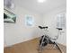 Bright home gym with natural light, laminate flooring, and modern stationary bicycle at 2796 Georgian W Dr, Brookhaven, GA 30341