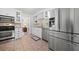 Modern kitchen featuring stainless steel appliances, granite countertops, and white cabinetry at 2796 Georgian W Dr, Brookhaven, GA 30341