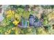 Aerial view of a property with a long driveway surrounded by beautiful mature trees and landscaping at 7185 Peachtree Dunwoody Rd, Atlanta, GA 30328