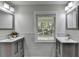 Large bathroom with double vanity, tiled floors and walls, and large mirrors at 7185 Peachtree Dunwoody Rd, Atlanta, GA 30328