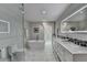 Bright bathroom featuring a soaking tub, glass shower, and double vanity with marble countertops at 7185 Peachtree Dunwoody Rd, Atlanta, GA 30328