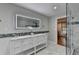 Bright bathroom featuring a glass shower and double vanity with marble countertops at 7185 Peachtree Dunwoody Rd, Atlanta, GA 30328