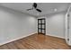 This bedroom features hardwood floors, neutral paint, a ceiling fan, and closet at 7185 Peachtree Dunwoody Rd, Atlanta, GA 30328