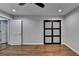 Modern bedroom with hardwood floors, recessed lighting, and a unique closet door design at 7185 Peachtree Dunwoody Rd, Atlanta, GA 30328