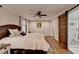 Bedroom with wood floors, barn door and a bathroom at 7185 Peachtree Dunwoody Rd, Atlanta, GA 30328