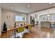 Open dining area with hardwood floors, a modern table setting, and seamless flow into the updated kitchen at 7185 Peachtree Dunwoody Rd, Atlanta, GA 30328