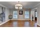 Bright dining room with hardwood floors, modern lighting, and windows at 7185 Peachtree Dunwoody Rd, Atlanta, GA 30328