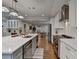 Contemporary kitchen with stainless steel appliances, quartz countertops and a seamless flow into the dining area at 7185 Peachtree Dunwoody Rd, Atlanta, GA 30328