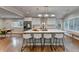 Bright, open kitchen featuring a large island with seating, modern appliances, and hardwood floors at 7185 Peachtree Dunwoody Rd, Atlanta, GA 30328