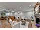 Spacious living room featuring a stone fireplace, hardwood floors, and ample seating at 7185 Peachtree Dunwoody Rd, Atlanta, GA 30328