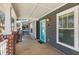 Covered front porch with brick columns and a vibrant blue door at 1126 Park Row South Se, Atlanta, GA 30312