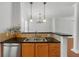 Kitchen area with tile backsplash, stainless steel sink, and black countertop at 1126 Park Row South Se, Atlanta, GA 30312