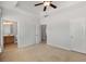 Main bedroom with ensuite bathroom, neutral carpeting, and a ceiling fan at 1126 Park Row South Se, Atlanta, GA 30312