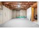 Unfinished basement features concrete and paneled walls with space for storage and utilities at 1331 Ashbury Park Dr, Hoschton, GA 30548