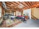 Open basement area with exposed wood and a entertainment area with rug and tv at 1331 Ashbury Park Dr, Hoschton, GA 30548