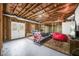 Spacious unfinished basement featuring exposed beams and white painted concrete floors at 1331 Ashbury Park Dr, Hoschton, GA 30548