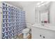 Bathroom featuring patterned shower curtain, white cabinets, and a single vanity at 1331 Ashbury Park Dr, Hoschton, GA 30548