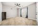 Large bedroom with neutral carpet, ceiling fan, and natural light at 1331 Ashbury Park Dr, Hoschton, GA 30548