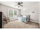 Bedroom featuring neutral carpet, ceiling fan, and a window at 1331 Ashbury Park Dr, Hoschton, GA 30548
