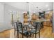 Cozy breakfast area adjacent to kitchen, featuring hardwood floors and bright lighting at 1331 Ashbury Park Dr, Hoschton, GA 30548