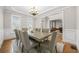 Elegant dining room with large table and chairs with adjacent living area at 1331 Ashbury Park Dr, Hoschton, GA 30548