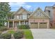 Charming two-story brick home with manicured lawn and attached two car garage at 1331 Ashbury Park Dr, Hoschton, GA 30548