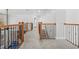 Hallway with carpet and wood and iron railing at 1331 Ashbury Park Dr, Hoschton, GA 30548