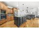 Kitchen with island, wooden cabinets, stainless steel appliances, and an eat-in breakfast nook at 1331 Ashbury Park Dr, Hoschton, GA 30548