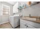 Laundry room features front load washer and dryer and utility sink at 1331 Ashbury Park Dr, Hoschton, GA 30548
