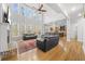 Open-concept living room with tall windows, fireplace and hardwood floors at 1331 Ashbury Park Dr, Hoschton, GA 30548