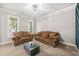 Bright living room with cozy seating, modern lighting and beautiful decor at 1331 Ashbury Park Dr, Hoschton, GA 30548