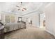 Large main bedroom with tray ceiling, carpet, and a fireplace at 1331 Ashbury Park Dr, Hoschton, GA 30548