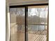 Balcony view showing lake surrounded by trees, seen through sliding glass doors at 1800 Clairmont Lk # A326, Decatur, GA 30033