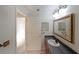 Bathroom featuring a granite countertop, sink, framed mirror, and a white paneled door at 1800 Clairmont Lk # A326, Decatur, GA 30033