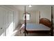 Spacious bedroom showcasing a four-poster bed, carpet floors, and a window with natural light at 1800 Clairmont Lk # A326, Decatur, GA 30033